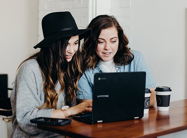 Two women learning in front of laptop