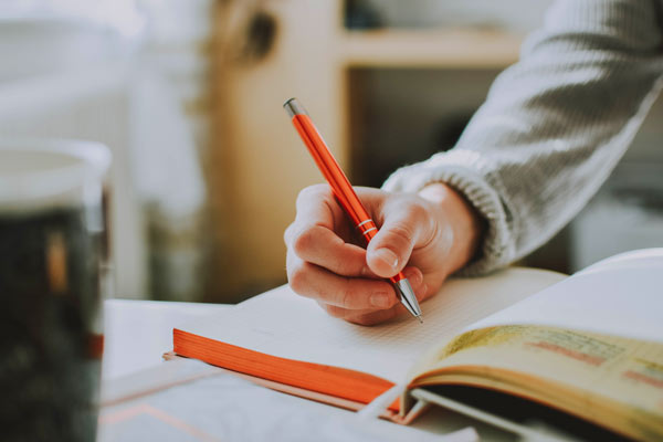 Teenager writing on graphing paper